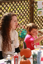 Kelly staffs the pumpkin painting table of the Open House